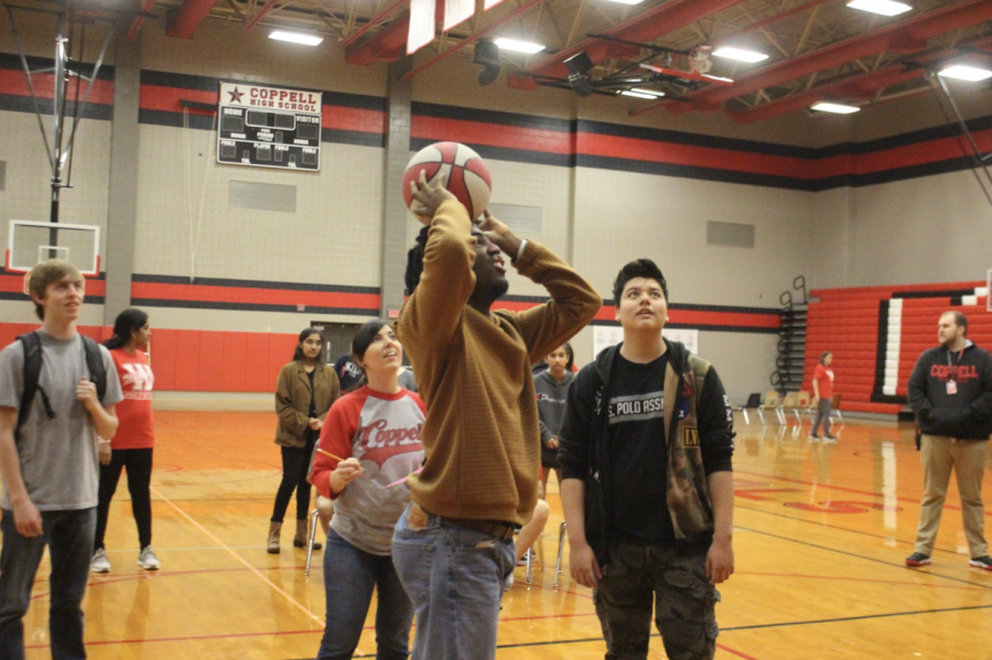 Coppell High School senior Miles Williams takes the shot at the first Special Olympics Skills Competition and Unified Games in the CHS large gym today. Williams and other special education students participate in order to test their physical activities skills.