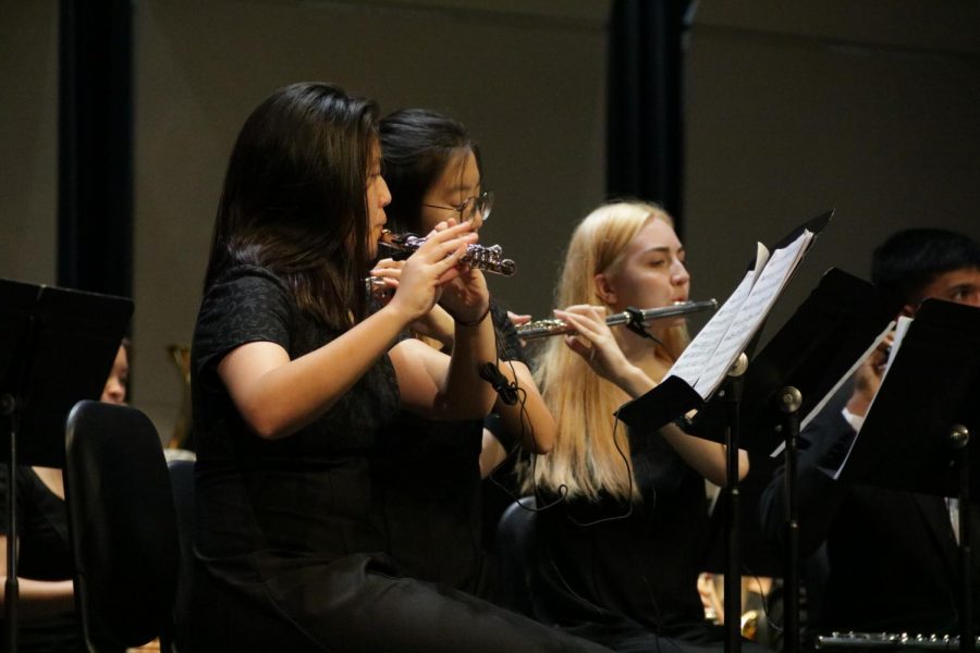 Coppell High School sophomores (now juniors) Kelly Kim, Eden Kim and New Tech High @ Coppell senior (now 2020 graduate) Marlee Moe play the flute at the Mid-Winter band concert last year in the CHS Auditorium. The annual concert showcases every band including CHS9 bands (Symphonic and Concert), Symphonic Band 1, Symphonic Band 2, Concert Band 1, Concert Band 2 and Wind Symphony. This year weather concerns have forced the band to turn to individual performances rather than a full showcase. 