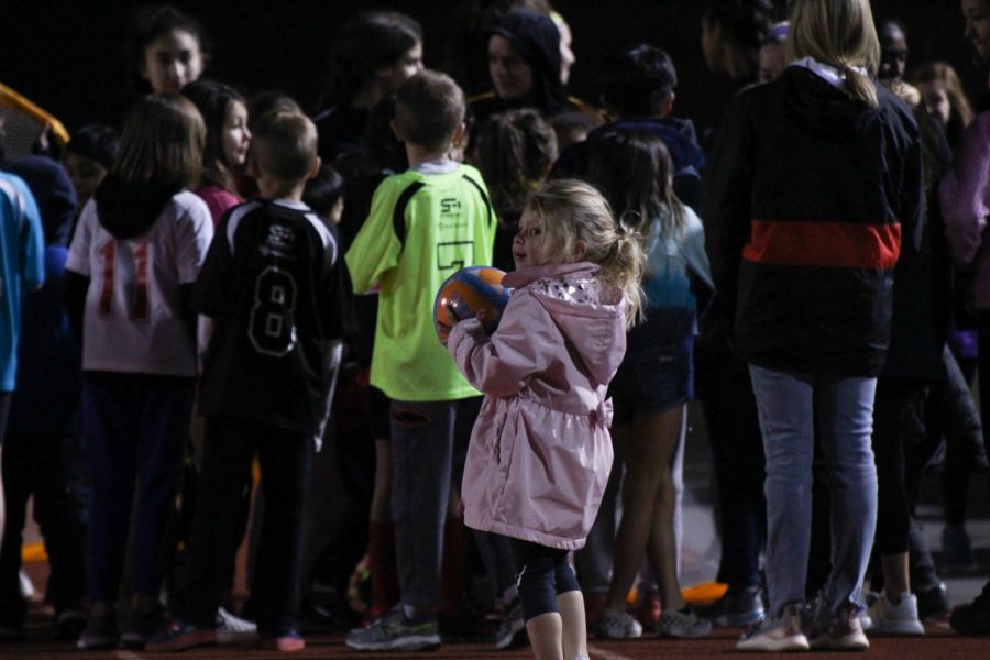 Three-year-old Addison Keogh joins other Coppell elementary school children on Buddy Echols Field for halftime activities on Friday. The Coppell girls soccer team hosted Youth Night for children to meet the Cowgirls and partake in halftime activities.