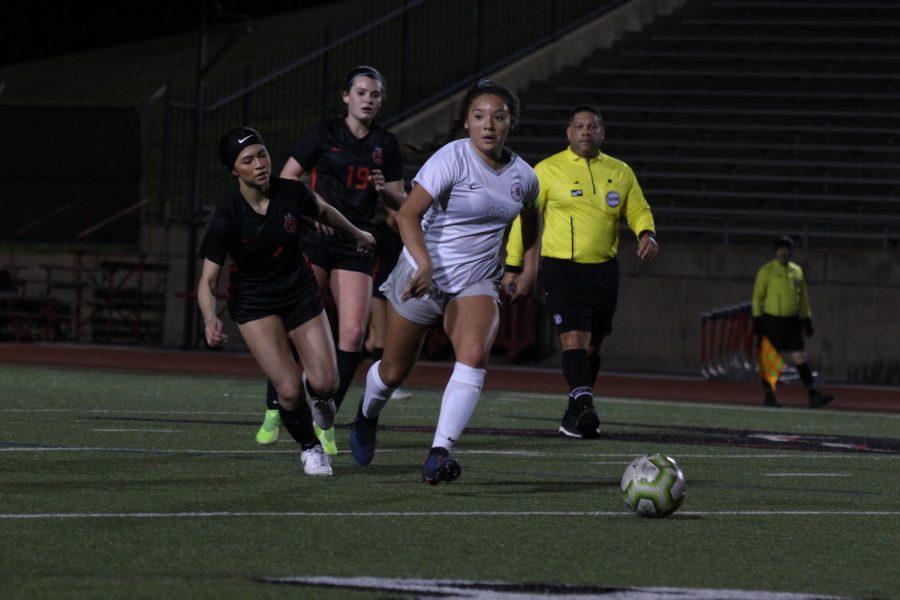 Lewisville junior midfielder Adamaris Manjarrez (right) escapes from Coppell senior forward Maggie Roberts (left) and sophomore midfielder Claire Yaney (19) on Friday at Buddy Echols Field. The Cowgirls defeated Lewisville, 5-1. 