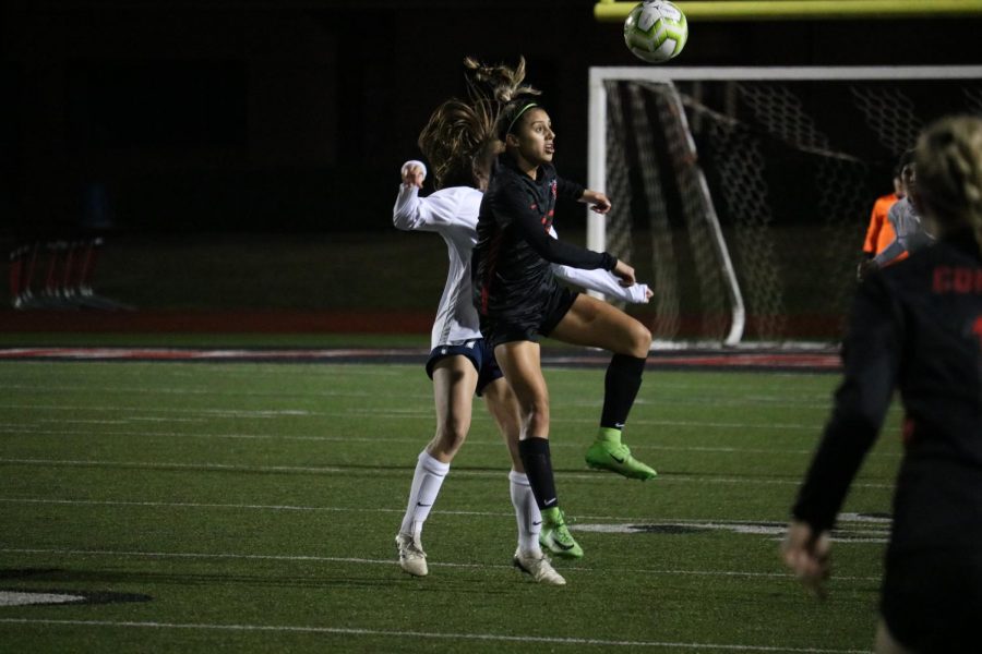 Coppell junior forward Jojo Alonzo wins a header against Flower Mound on Feb. 11 at Buddy Echols Field. The Cowgirls face Irving tomorrow at 7:30 p.m. at Buddy Echols Field.