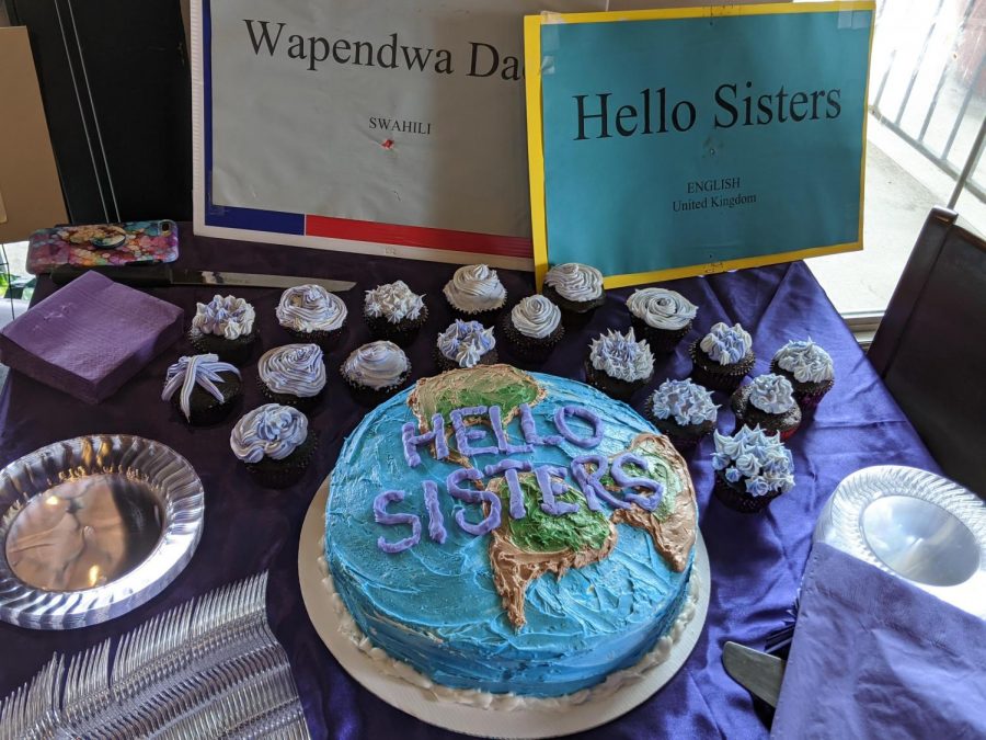 Homemade cakes and cupcakes are arranged on a table alongside signs that read ‘hello sisters’ in different languages at a Women’s Day event at Andalous Mediterrean Buffet in Richardson on March 8. The event commemorated International Women’s Day and Women’s History Month. 