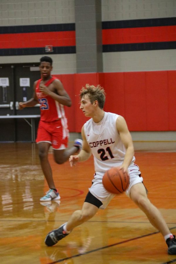 Coppell junior guard Ben Klement looks for an open teammate against Arlington Lamar on Nov. 21. Klement uses time management to balance sports and school in his daily life.
