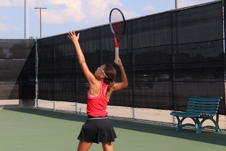 Coppell freshman Lindsay Patton serves during eighth period tennis  practice at the CHS Tennis Center. Patton has risen to the top ranks of the girls tennis team in a matter of a year, where she competes against players bigger and older than her.