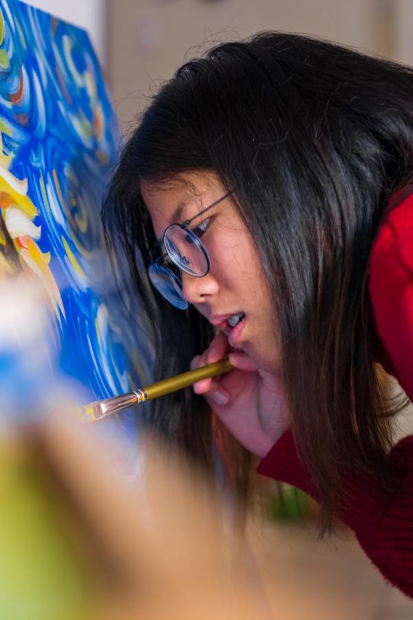 Coppell High School senior Celeste Wang paints a sunflower for her Girl Scout Gold Award Project. She donated these paintings to abused and impoverished women, bringing positivity into their lives. 
