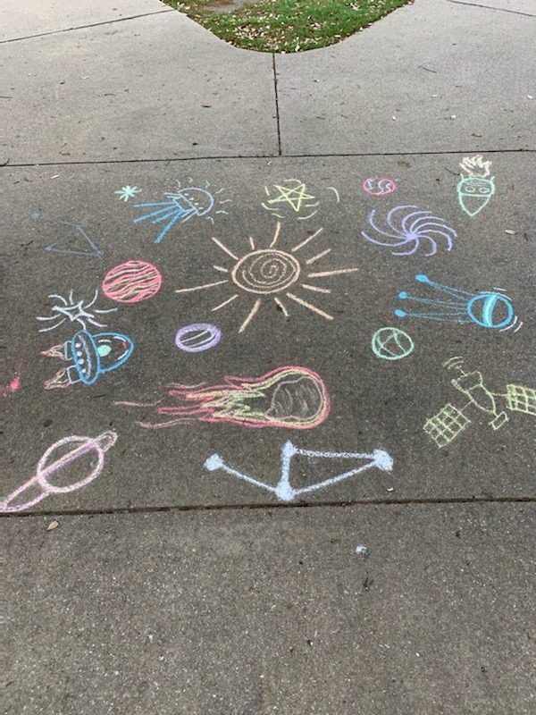 Various chalk drawings decorate the sidewalk in front of Kid Country playground at The CORE on April 5. All playgrounds in Coppell are closed out of concern for the public’s safety amid COVID-19.