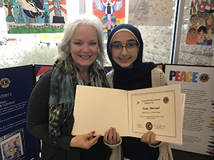 Coppell Middle School West eighth grader Sana Abusaad won first place at the multi-district level of the  International Peace Poster Contest with Coppell Middle School West Art teacher Gail Cary. Abusaad’s poster will move on to be judged at the international level. Photo courtesy Coppell ISD