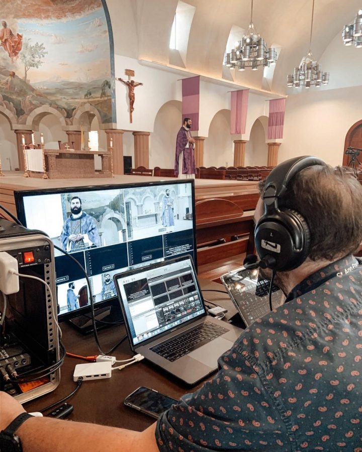 St. Ann Catholic Parish director of youth ministries Joey Seaneella operates recording technology as Fr. Paul Bechter gives a sermon. St. Ann is one of the many local religious institutions that has turned to live streaming to provide its services. Photo courtesy Kurt Klement 