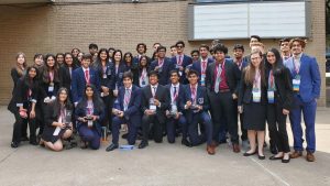 Coppell High School DECA state winners and finalists pose with their trophies and medals outside the Fort Worth Convention Center on Feb. 22. Sixteen students from CHS advanced to internationals, which was canceled due to the COVID-19 pandemic. 
