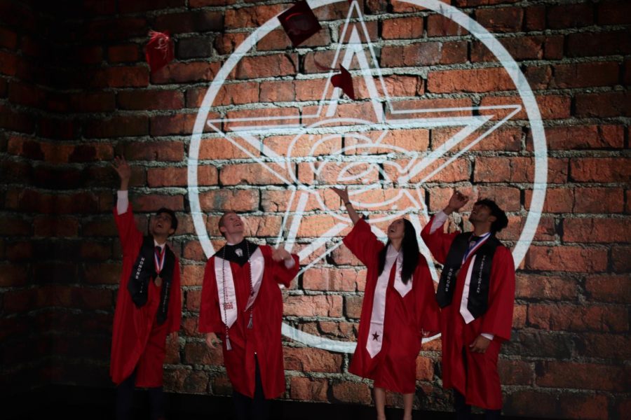 Coppell High School seniors Het Desi, Leo Swaldi, The Sidekick staff writer Sara Woo, and Prayaag Gupta throw their caps after filming the CHS virtual graduation at Event Technology Services on Wednesday. CHS is holding a virtual graduation ceremony on May 28.