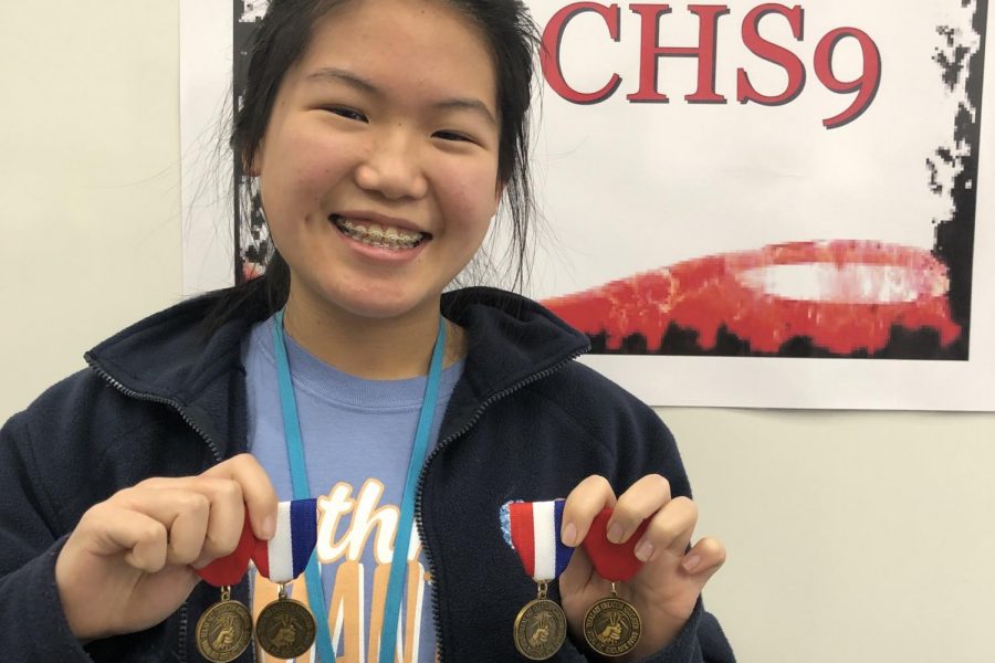 CHS9 student Ashley Zhang displays her VASE medals at CHS9. Zhang is one of four Coppell students whose artworks received a gold seal at the state VASE competition.