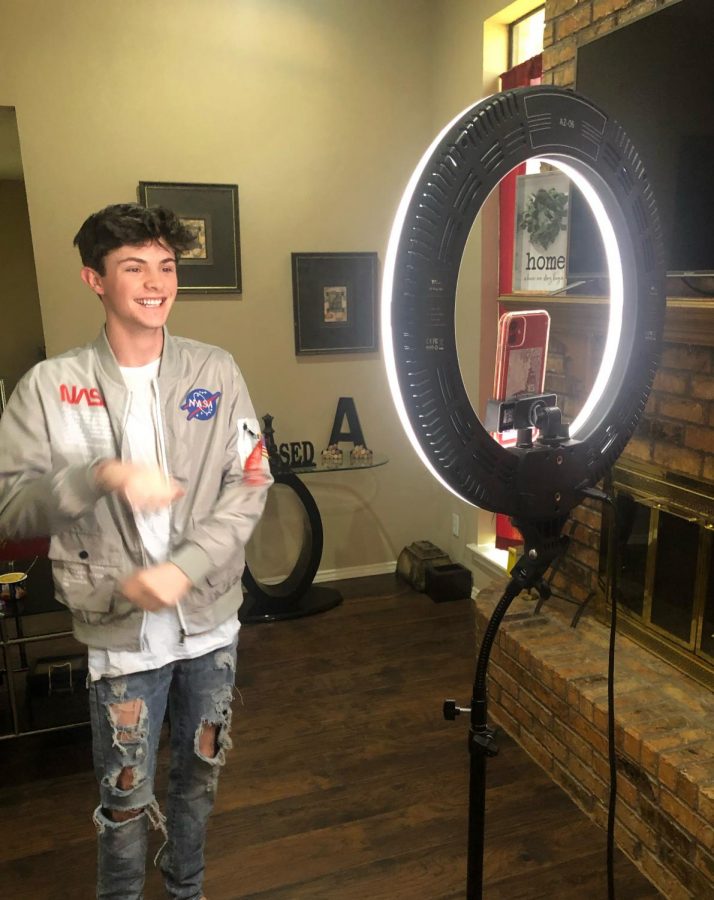 Coppell High School senior Trevor Williams makes TikToks in front of his ring light in his living room on May 5. Williams started making TikToks as a way to eliminate his boredom and in the process found his love for content creation.