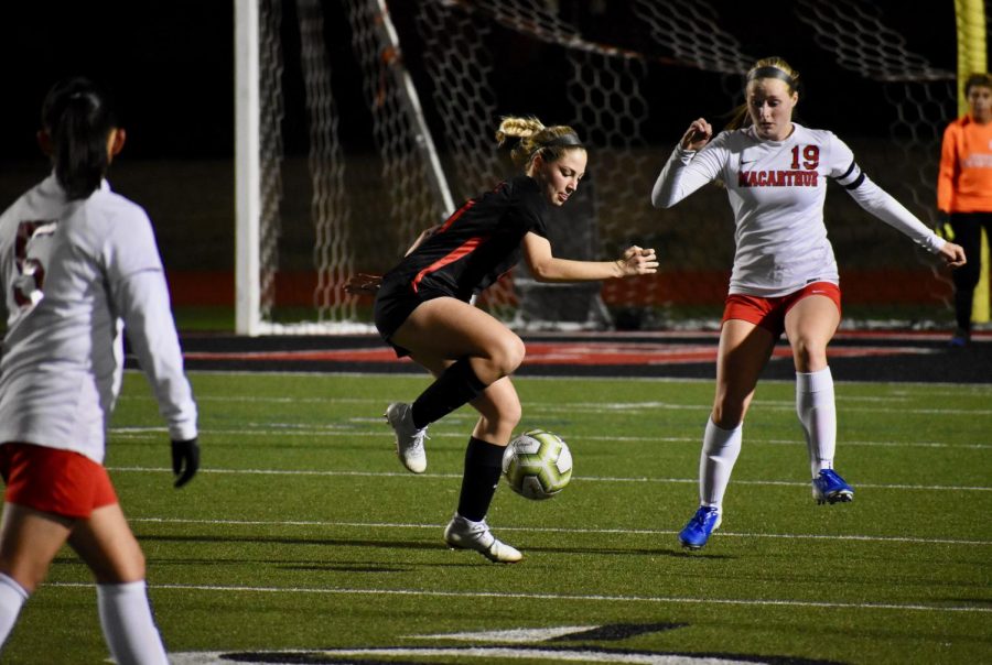 Coppell+junior+defender+Emma+Hubert+receives+from+the+air+against+Irving+Macarthur+on+Jan.+24+at+Buddy+Echols+Field.+Hubert+is+one+of+12+Cowgirls+awarded+a+District+6-6A+award.