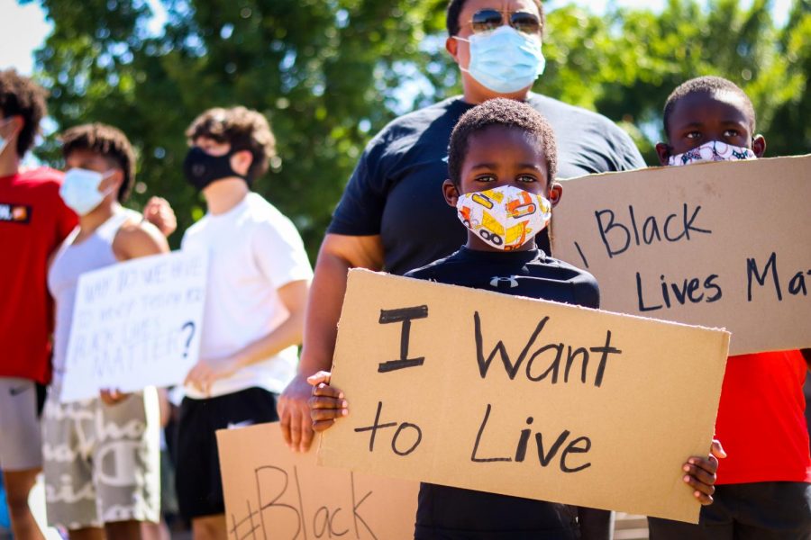 Young protestor, Ben, holds up his sign in order to support the Black Lives Matter movement at Town Center Plaza in Coppell on June 3. The Coppell community rallied together to spread awareness about BLM and fighting against racial injustice.