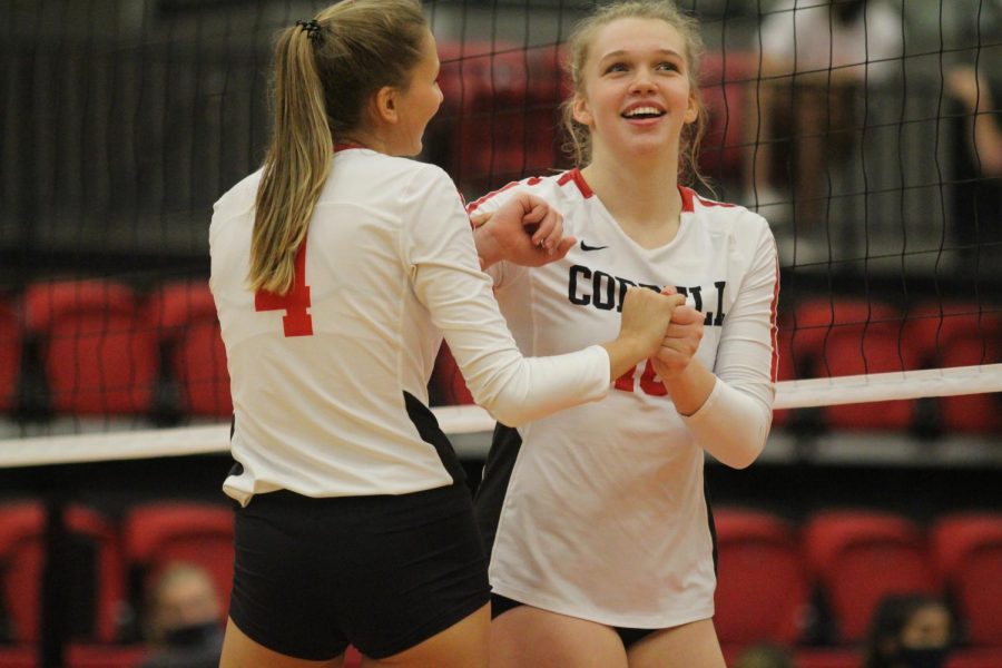 Coppell junior right-side hitter Abigail Hendricks and sophomore outside hitter Reagan Engler celebrate in the CHS Arena on Friday. Coppell defeated Prosper Rock Hill, 25-23, 25-18, 25-11. 