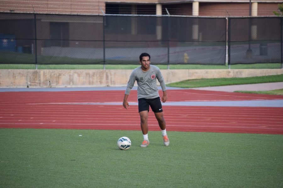 Coppell junior defender and The Sidekick co-sports editor Meer Mahfuz shoots during an individual practice on Aug. 25 at Buddy Echols Field. Mahfuz reflects on last year’s season and explains how the process of returning to athletic play this season has impacted him.
