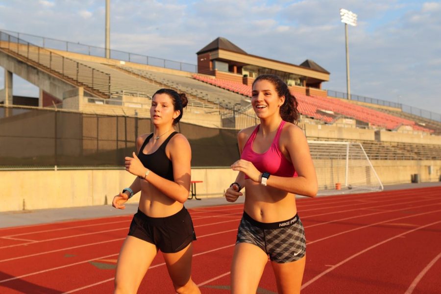 Coppell senior Chloe Hassman and junior Waverly Hassman run during cross country practice at Buddy Echols Field on Tuesday morning. Hassman committed to the University of Pennsylvania for track and field and cross country on Aug. 22. Photo by Lilly Gorman.