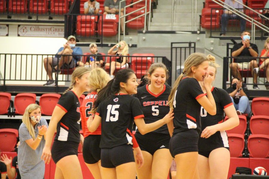 The Cowgirls embrace after winning a tough point against Sachse on Sept. 18 at the CHS Arena. Coppell plays Prosper Rock Hill, Rockwall and McKinney Boyd this Friday and Saturday.