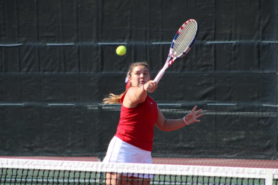Coppell senior Jackie Gamborino backhand volleys against Plano West on Friday at the CHS Tennis Center. Coppell lost to Plano West, 13-6.  
