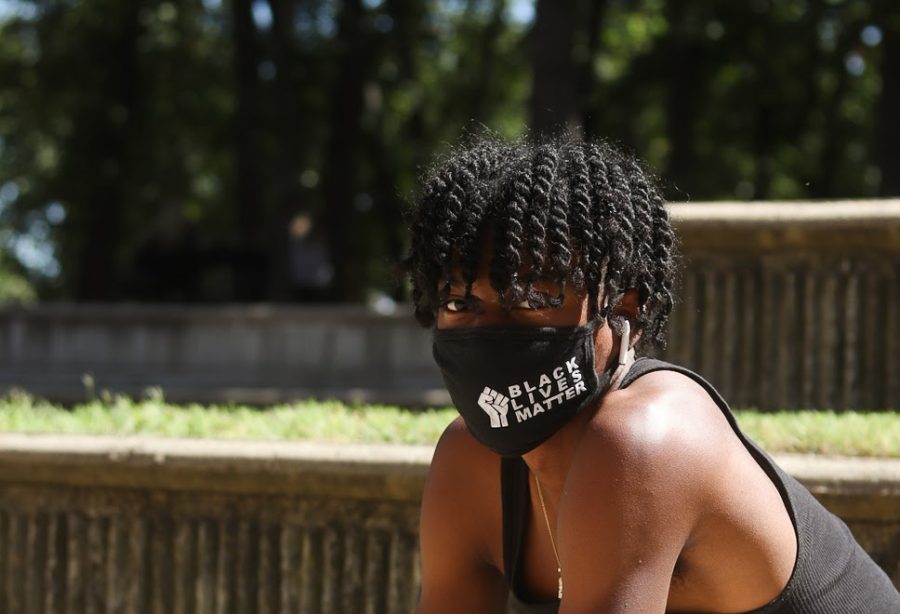 Coppell High School junior Davion Belford wears a Black Lives Matter mask in the Horseshoe during C lunch on Wednesday. CHS students have been using masks as a form of self expression during the COVID-19 pandemic.
