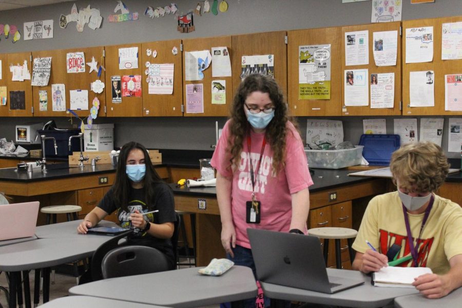 Coppell High School honors chemistry, IB chemistry and IB chemistry II teacher Susan Sheppard helps CHS juniors Julia Cherkesov and Sven Collins with classwork during third period class on Sept. 9 in C202. Sheppard was selected as The Sidekick’s Teacher of the Issue.