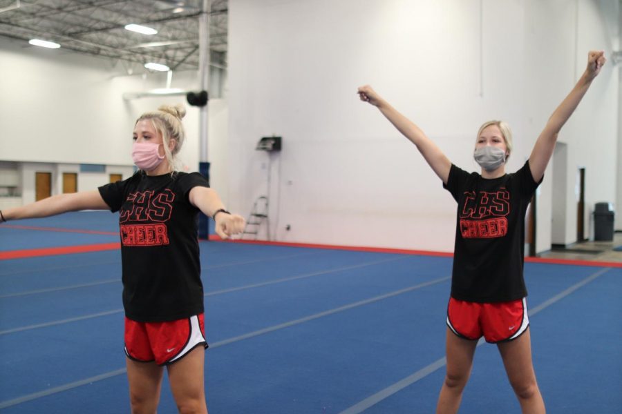 Coppell senior cheerleader Tenley Colclasure and freshman cheerleader Tali Colclasure practice routines at the Spirit of Texas gymnasium on Sept. 28. Despite different athletic backgrounds, the Colclasure sisters are now both a part of the Coppell cheer team.