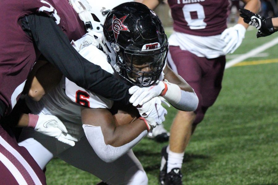 Coppell+senior+Jason+Ngwu+is+tackled+by+Plano+defenders+at+John+Clark+Stadium+on+Oct.+23.+Coppell+plays+Plano+West+tomorrow+for+its+homecoming+game+at+Buddy+Echols+Field+at+7+p.m.