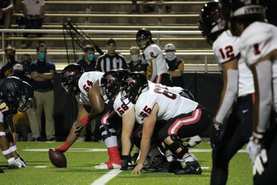 Coppell senior center Febechi Nwaiwu, senior offensive linemen Austin Darcy and sophomore offensive lineman Trevor Timmerman prepare for a play against Highland Park at Highlander Stadium on Oct. 9. The Sidekick executive editor-in-chief Sally Parampottil believes linemen are essential to football but often go underappreciated.