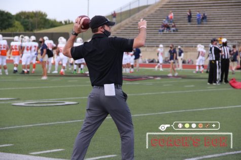 Coppell assistant Blaine Barnett passes during pregame warmups before the Cowboys’ 42-35 victory against Sachse on Oct. 2 at Buddy Echols Field. In addition to coaching football, Barnett teaches special education at Coppell High School. 