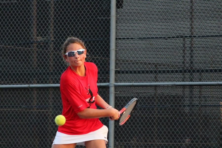 Coppell sophomore Lindsay Patton hits a backhand against Lewisville’s Amber Rhodes on Tuesday at the CHS Tennis Center. Patton won her singles match, 7-5 and 7-6 (2), and Coppell defeated Lewisville, 19-0. 