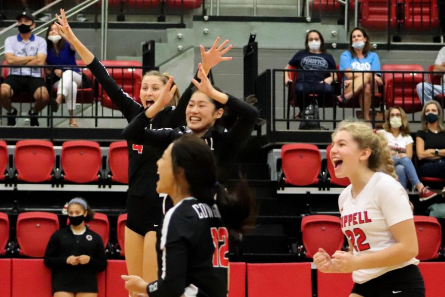 Coppell junior right side Abby Hendericks, senior setter Mari Taira, junior defensive specialist Meagan Lee and junior libero Rebeca Centeno celebrate after scoring against Hebron at the CHS Arena on Friday. Coppell swept Hebron, 25-21, 25-20, 25-16, to bring its District 6-6A record to 2-2.