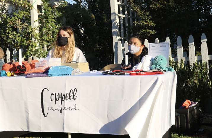 New Tech High @ Coppell sophomore Payton Hoenig and Coppell High School sophomore Reagann Stolar sell handmade products for their business, Coppell Crafted, on Saturday at Old Town Coppell. Stolar and Hoenig started Coppell Crafted as a hobby and developed it  to help the city by donating a portion of profits to various charities and movements. Photo by Nandini Muresh