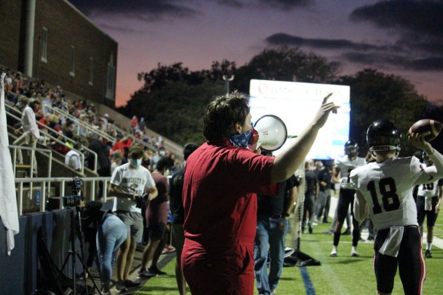  Coppell High School senior Plunger Boy Ryan Tompkins cheers from the sidelines during Coppell’s game against Highland Park on Oct. 9 at Highlander Stadium. In the midst of a pandemic, Tompkins leads the student section and cheers Coppell in their victory.