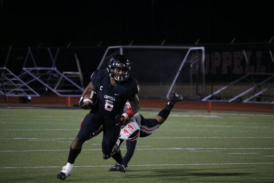 Coppell senior running back Jason Ngwu dodges Flower Mound Marcus senior defensive lineman Bryson Wade on Nov. 6 at Buddy Echols Field. The Cowboys face Lewisville tomorrow at 7 p.m. at Buddy Echols Field for Senior Night. 