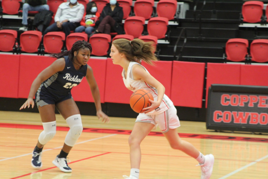 Coppell+sophomore+guard+Jessie+Huff+drives+past+Richland+junior+Madison+Jackson+at+the+CHS+Arena+on+Tuesday.+The+Cowgirls+face+Colleyville+Heritage+tomorrow+at+6%3A30+p.m.+in+the+CHS+Arena.