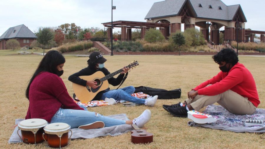 Coppell High School juniors Faiza Rahman, Raghav Vemuganti and Joseph Mathew get together for the first time since March, when they last played together, at Andy Brown Park East over Thanksgiving break. Vemuganti, Rahman and Mathew have created and released music together without meeting in person over the summer.