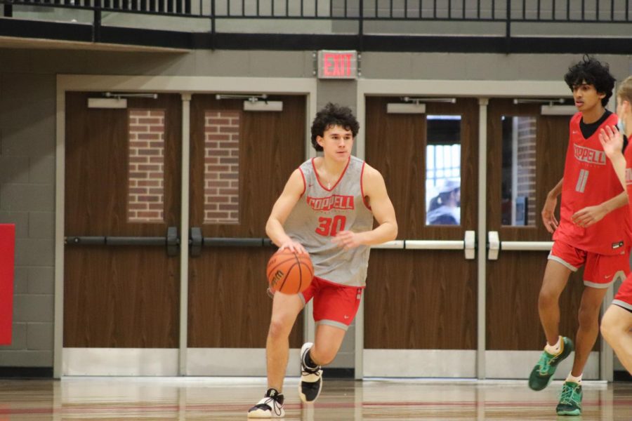 Coppell+junior+shooting+guard+Will+Kimball+dribbles+across+the+court+during+first+period+practice+at+the+CHS+Arena+on+Thursday.+The+Cowboys+play+against+Keller+tomorrow+night+at+8+p.m.+
