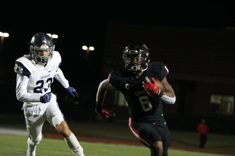 Coppell senior running back Jason Ngwu rushes against Flower Mound on Friday at Buddy Echols Field. With a 51-28 win over the Jaguars, the Cowboys face Denton Guyer on Saturday at 1 p.m. at C.H. Collins Complex in Denton in the Class 6A Region I bi-district playoffs.