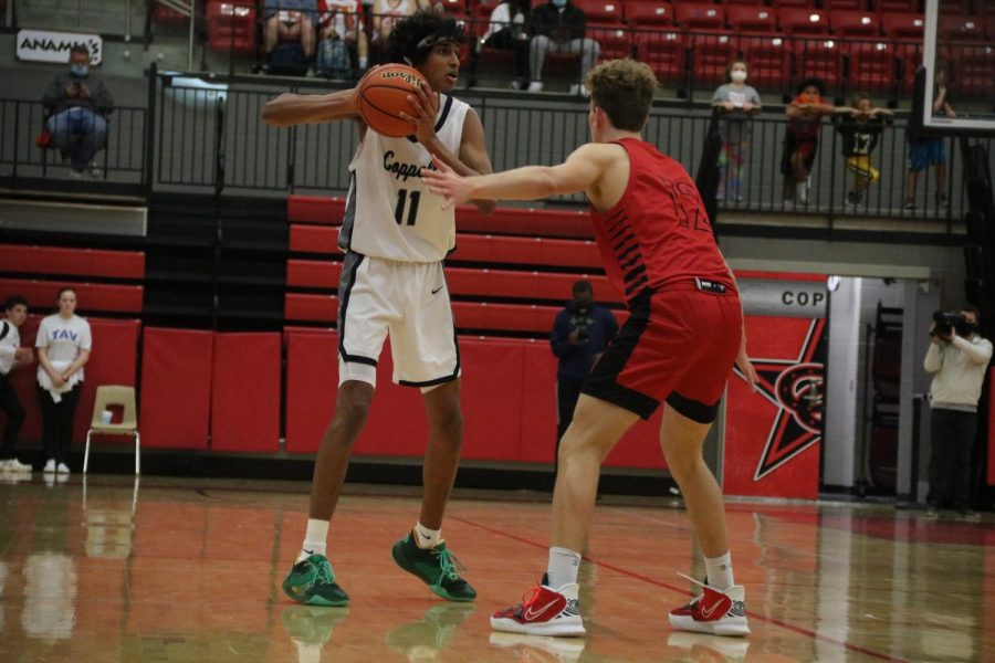Coppell junior shooting guard Ryan Agarwal shoots against Hebron senior David Deal on Tuesday at the CHS Arena. The Cowboys defeated Hebron, 66-56.