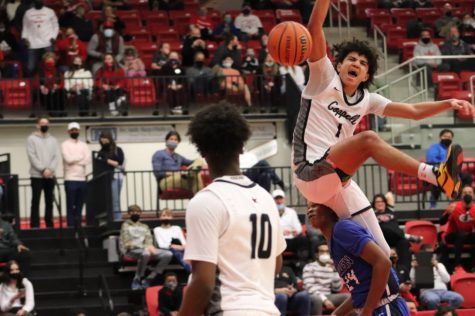 Coppell junior guard Naz Brown watches junior guard Anthony Black dunk against Allen during the second quarter at the CHS Arena on Feb. 20. Black announced his decision to commit his future to basketball over the weekend at the War Before The Storm tournament in the Advantage Sports Complex in Carrollton. 