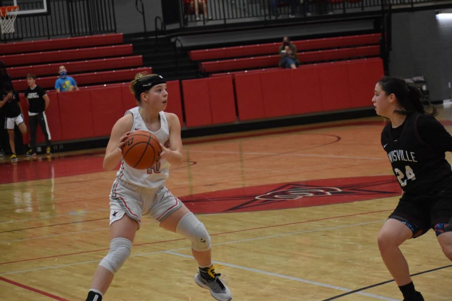 Coppell senior guard Emma Sherrer looks for a teammate against Lewisville on Friday at the CHS Arena. The Cowgirls host Flower Mound tomorrow at the CHS Arena at 6:30 p.m. in their last game of the season. 