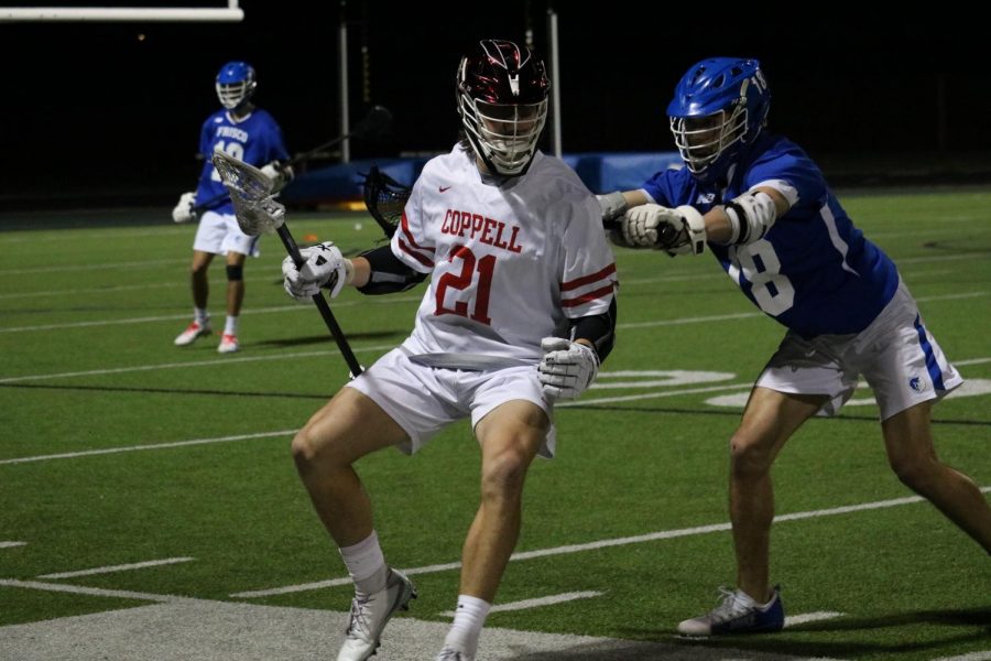 Coppell senior midfielder Bain Carter shields defensive pressure last season against Frisco at Coppell Middle School North. The Cowboys host Plano West in the season opener tonight at 7:30 p.m. at Lesley Field.