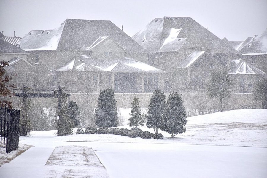 Snow falls and covers homes in the Parkside Community in Irving on Sunday. Coppell experienced snowfall on Sunday, and there is a winter storm warning for the Dallas-Fort Worth area as per the National Weather Service. 