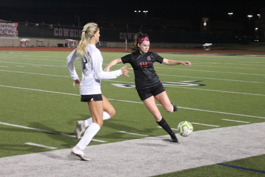 Coppell junior midfielder Claire Yaney passes against Flower Mound Marcus junior forward Paige Dickson at Buddy Echols Field on Friday. The Cowgirls defeated the Marauders, 2-1.
