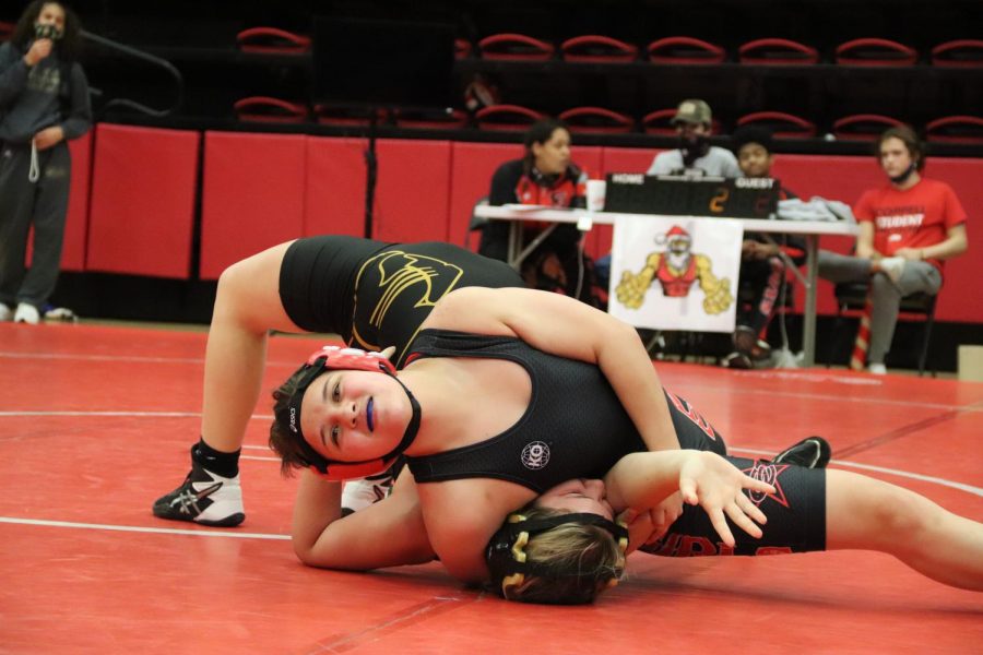 Coppell sophomore wrestler Casey Sparks attempts to pin a Fossil Ridge wrestler at the annual Santa Slam meet on Friday in the CHS Arena. The Cowgirls won many of their matches, though official scores have not been imputed yet.