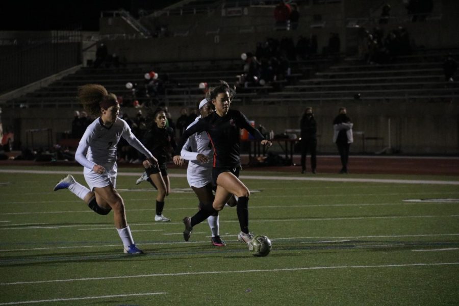 Coppell junior forward Michelle Pak attempts to score against Lewisville defender Averi Culver at Buddy Echols Field on March 5. Coppell plays Prosper in the Class 6A Region I bi-district playoffs tomorrow at McKinney ISD Stadium at 7:30 p.m. 