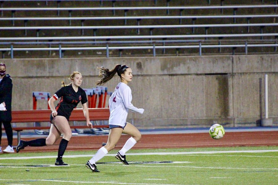 Coppell senior defender Addison Marten chases down Plano junior defender Kamryn Pham at Buddy Echols Field on Monday.  The Cowgirls tied with the Wildcats, 1-1.
