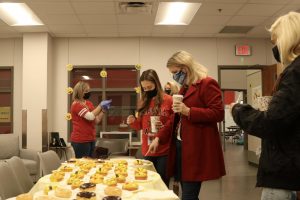 The CHS9 Sunshine Committee hands out donuts and coffee to faculty as they celebrate national “I Want You To Be Happy” day on Wednesday. The Sunshine Committee hosts events every year since 2018 to celebrate major life events and boost the morale of the staff.