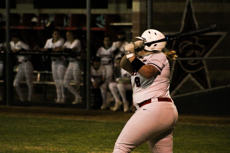 Coppell senior first baseman Michaella Baker hits a solo homerun in the third inning against Plano West yesterday at the Coppell ISD Softball Complex. The Cowgirls defeated Plano West, 6-3, in their District 6-6A home opener. 