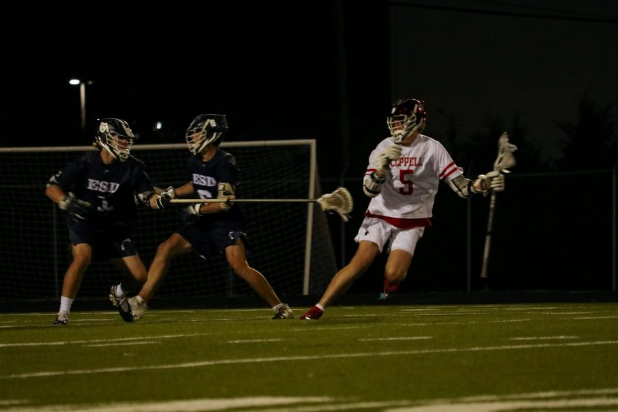 Coppell senior midfielder Andrew Sullivan dodges against Episcopal School of Dallas  at Lesley Field on Wednesday. The Cowboys lost to the Eaglese, 13-8.